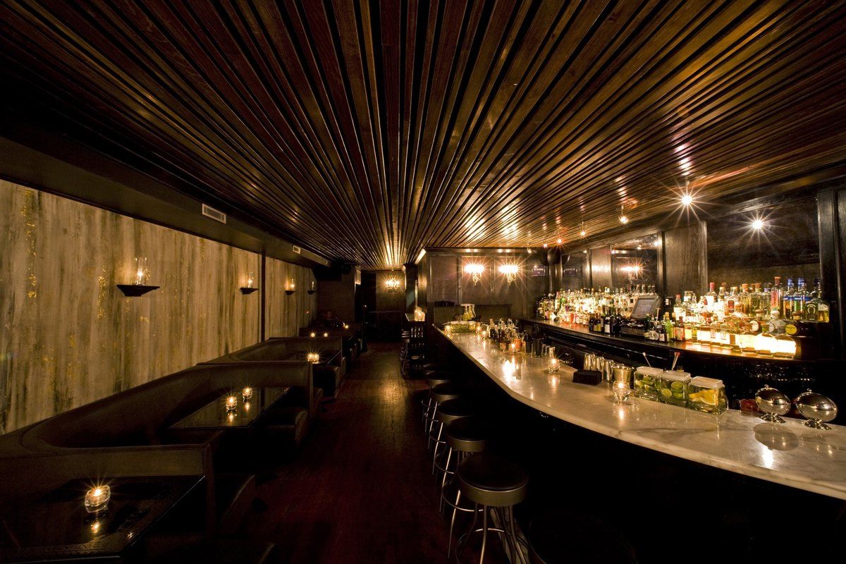 The dark wood-panelled bar room of Death & Co in the East Village