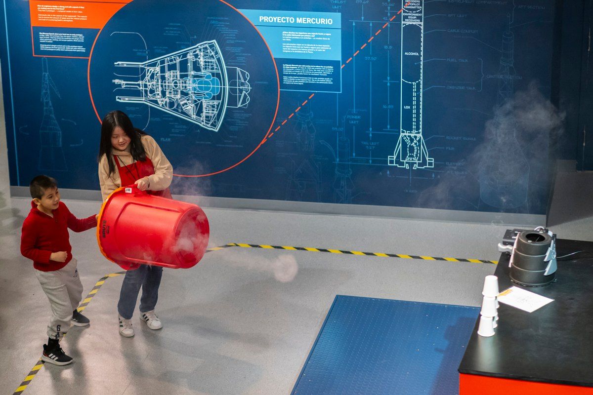 Children experimenting with an air-cannon exhibit at the New York Hall of Science