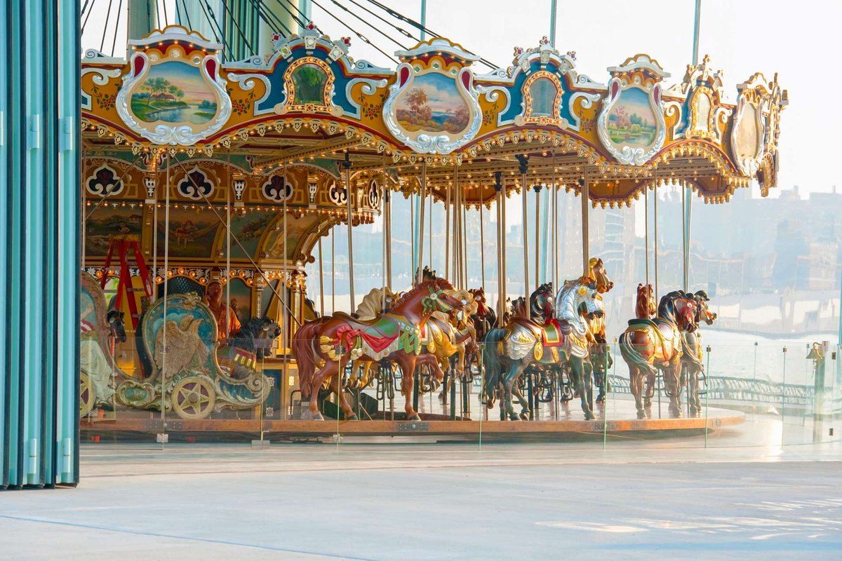 The painted horses of Jane's Carousel inside its glass pavilion in Dumbo