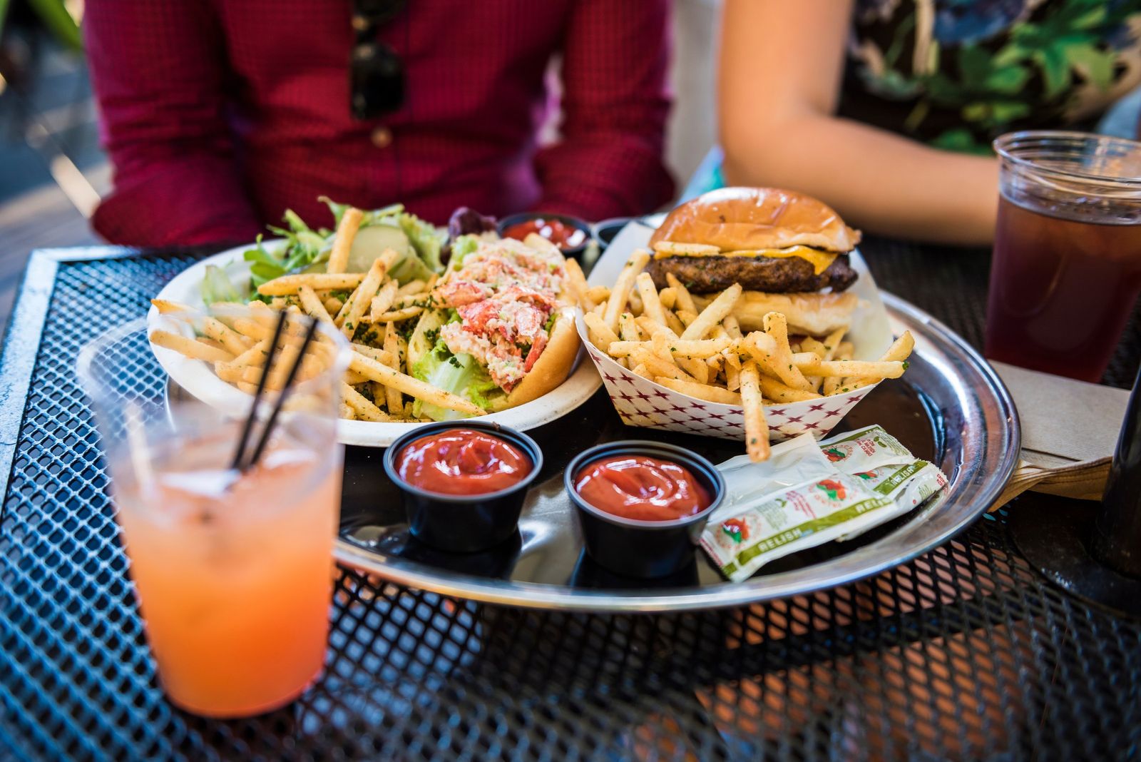 A lobster roll and a burger with fries