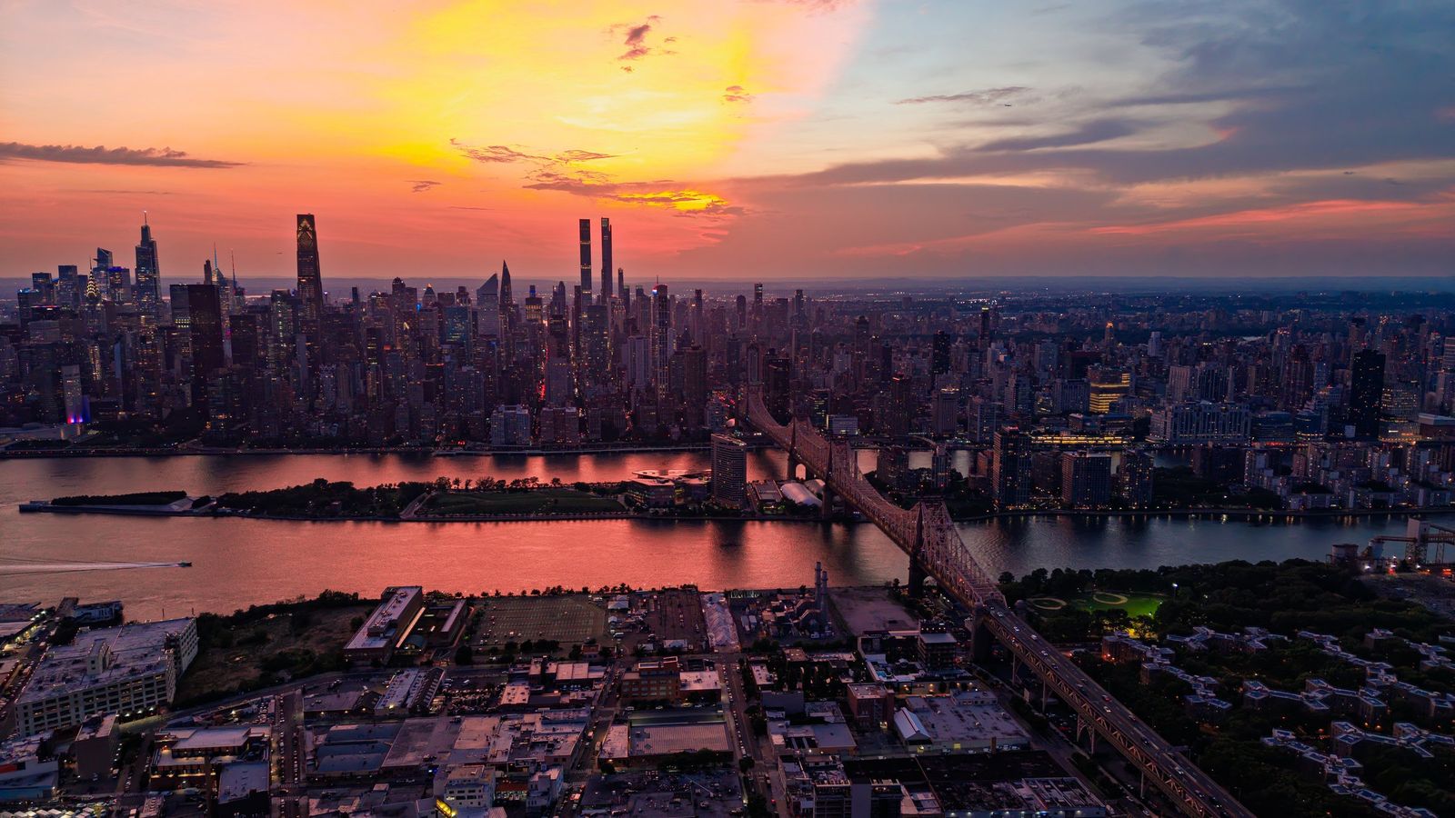 Manhattan at dusk, with the Queensboro Bridge over the East River