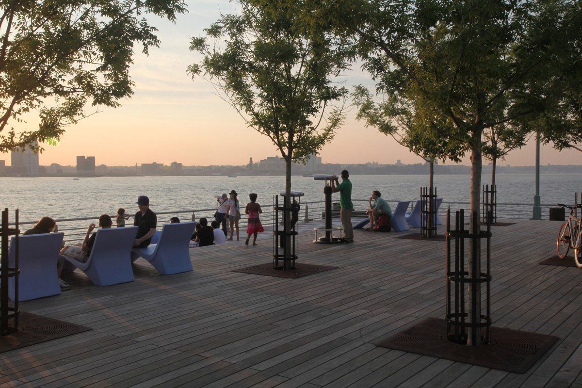 The wooden deck at the end of Pier 25 in Hudson River Park at sunset