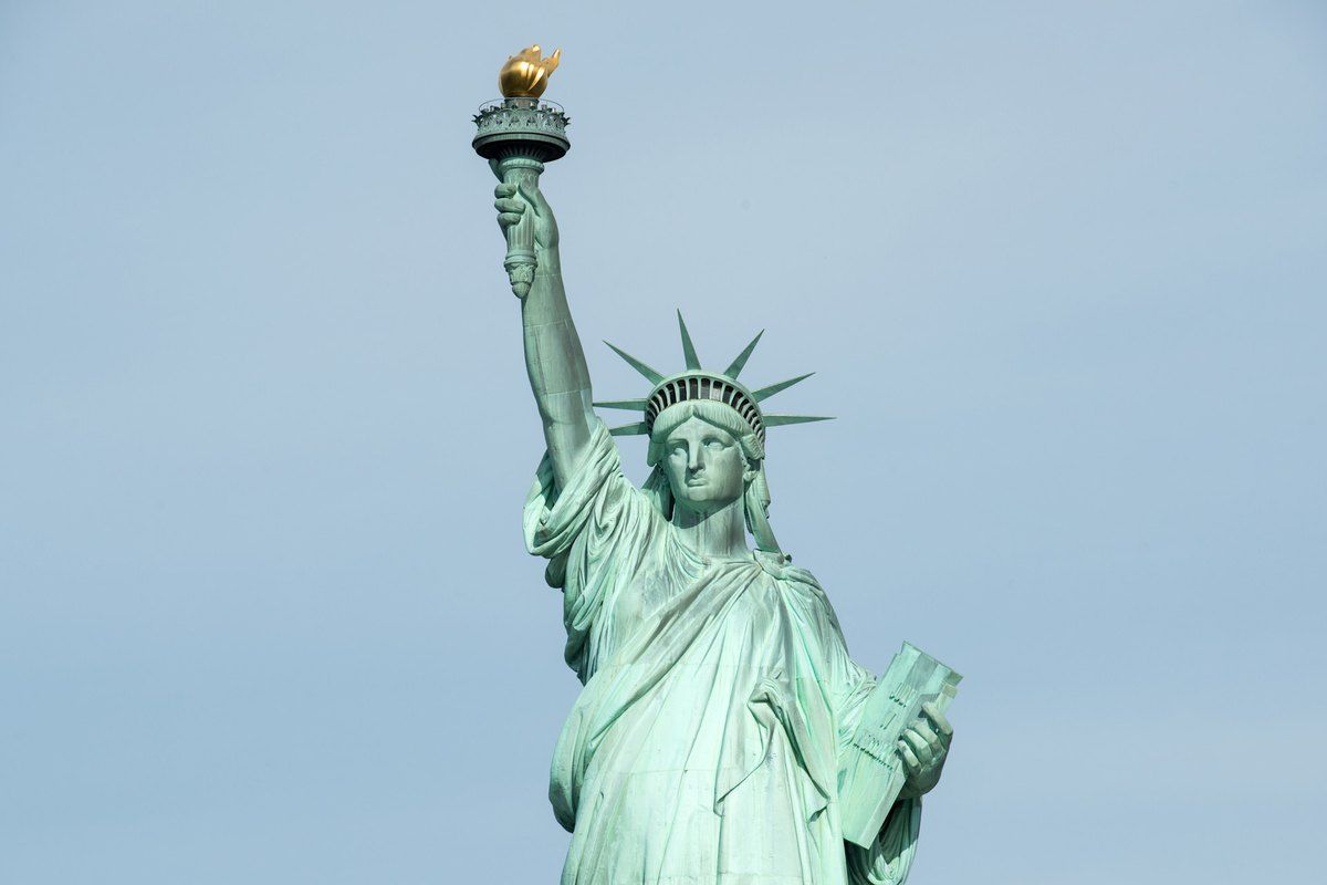 The Statue of Liberty against a clear blue sky