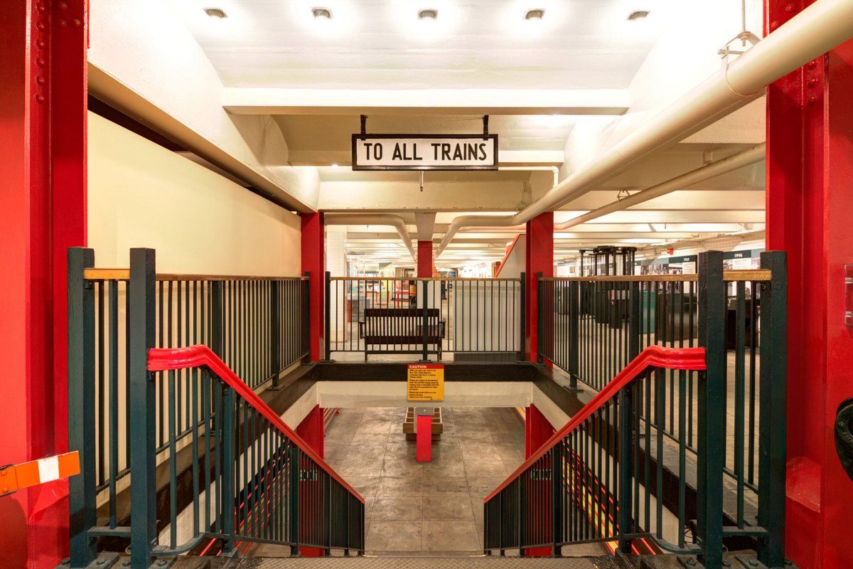 The vintage turnstiles and 'To all trains' sign inside the New York Transit Museum's old Court Street station