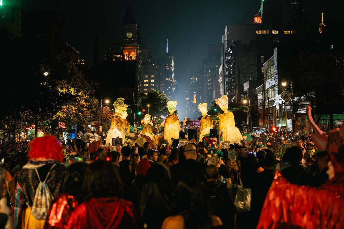 Giant lit puppets and costumed marchers on Sixth Avenue during the Village Halloween Parade
