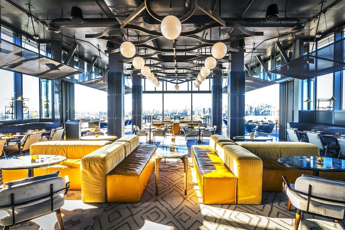 Yellow banquettes and floor-to-ceiling windows at Westlight on the 22nd floor of The William Vale
