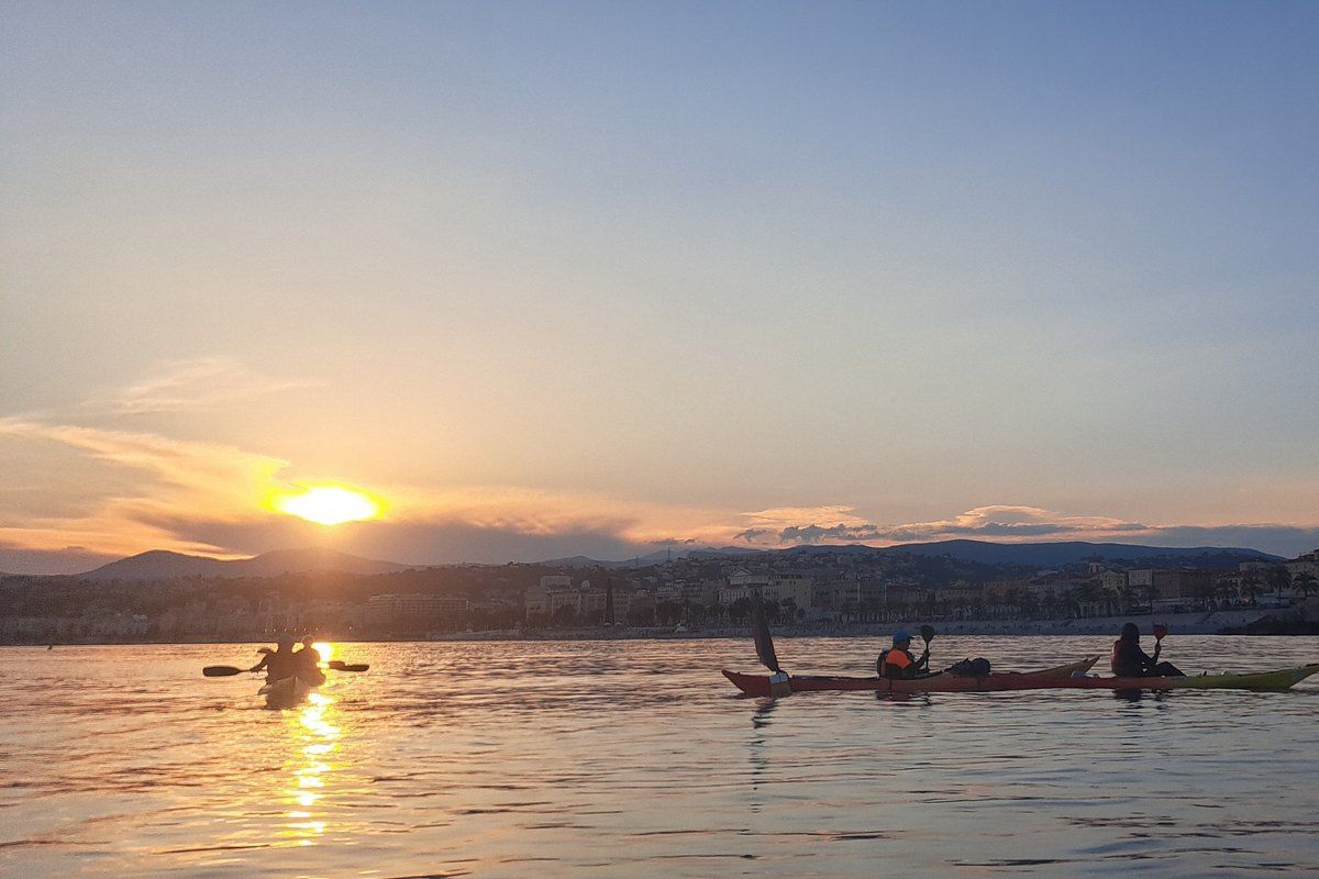 Sea kayaks with the Club de la Mer on a calm sea off Nice at sunset