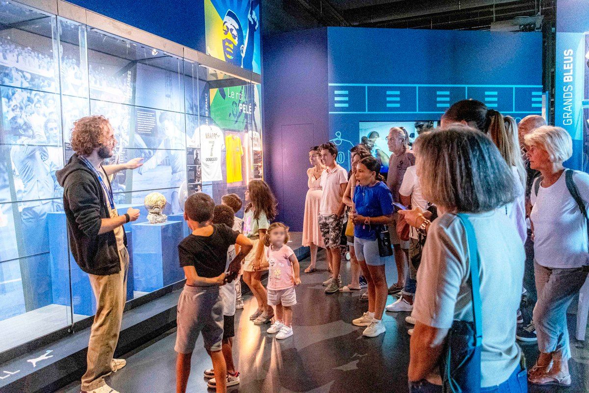 A guide showing children and parents the football displays in the Musée National du Sport at the Allianz Riviera, Nice