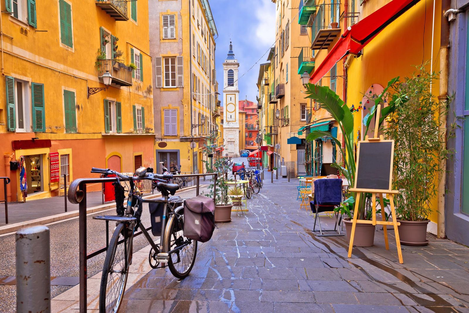A colourful street and church in the old town of Nice