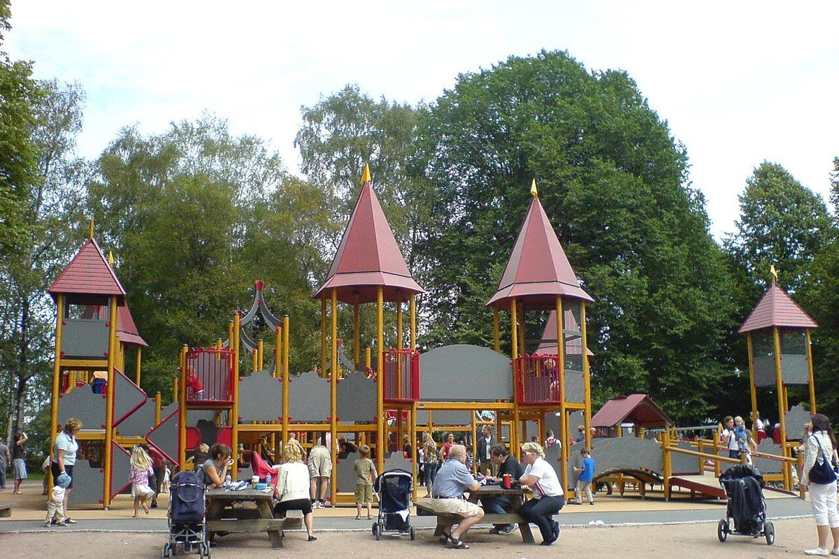 Families at the Frognerborgen castle playground with its red-roofed towers in Frogner Park, Oslo