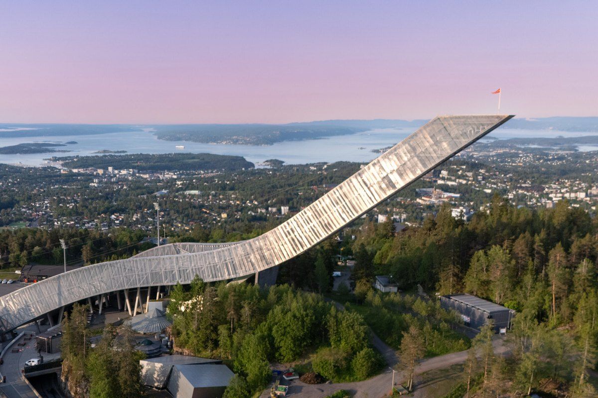 The Holmenkollen ski jump above the forest with Oslo and the fjord spread out below