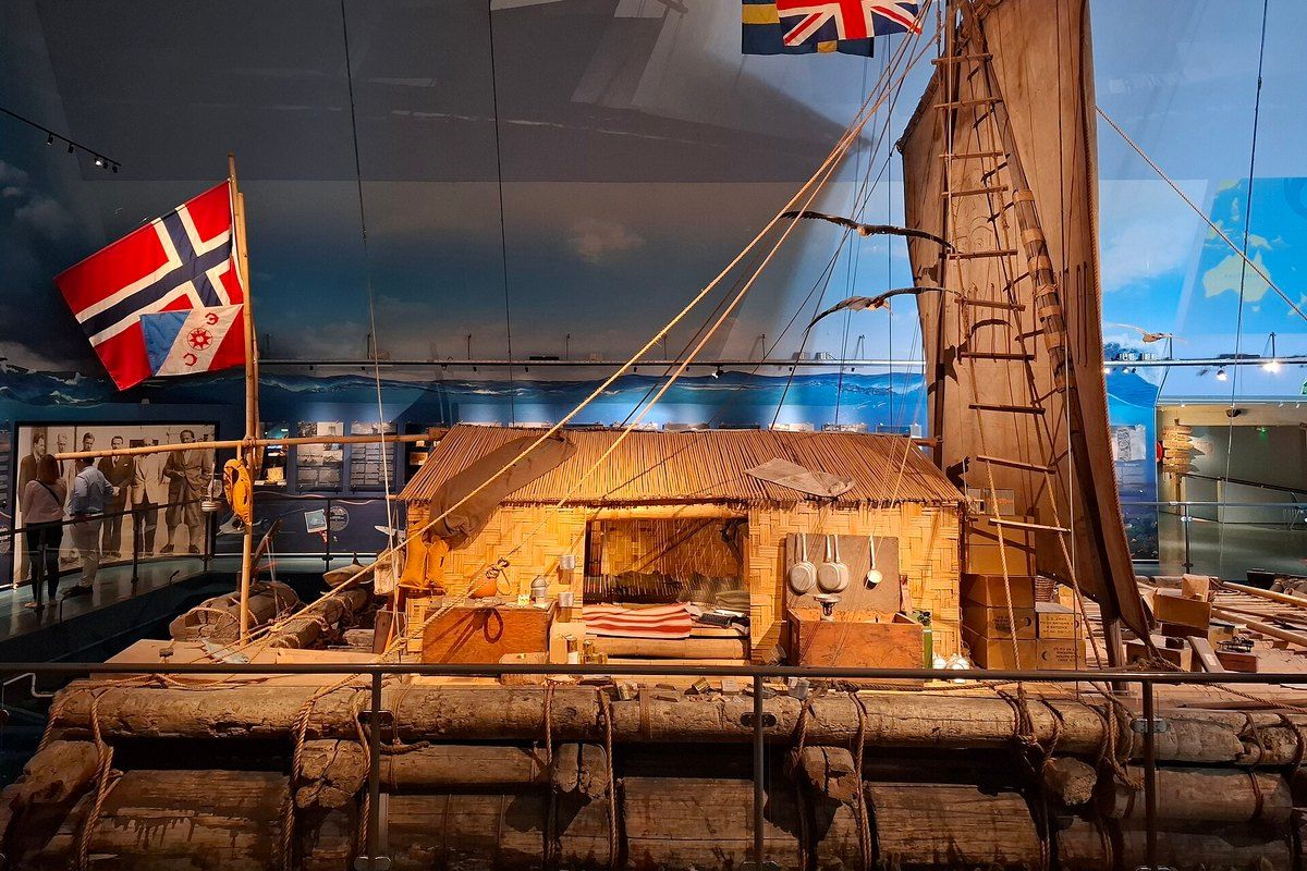 The Kon-Tiki raft with its bamboo cabin, sail and flags on display at the Kon-Tiki Museum, Oslo