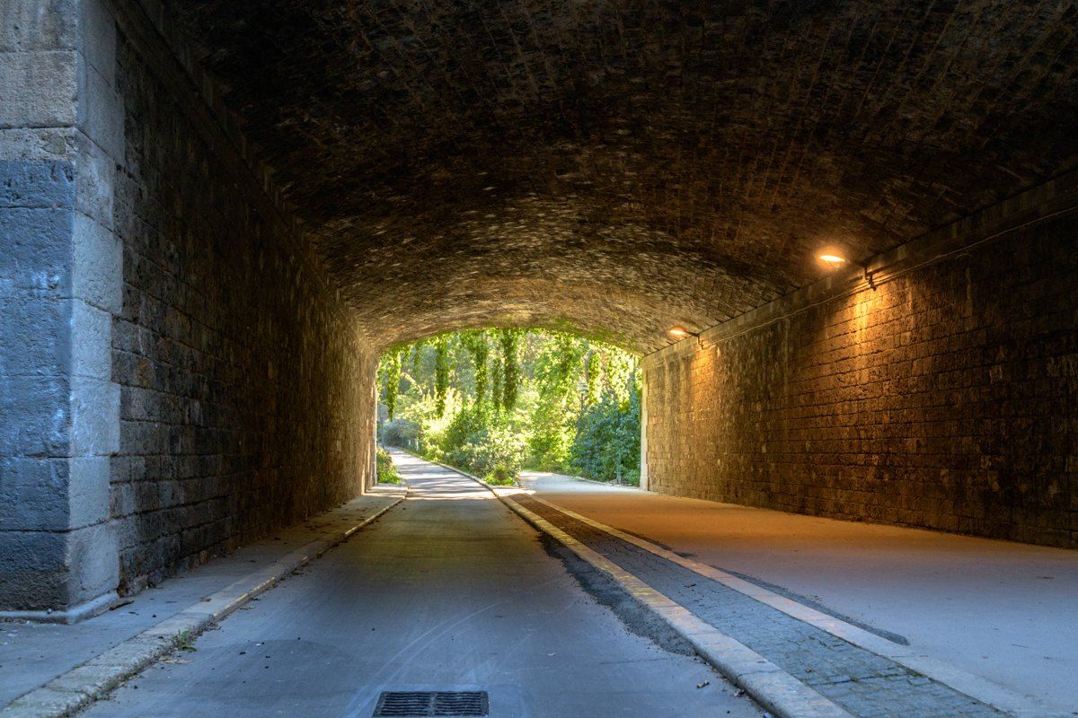 A lit tunnel opening onto a garden on the Coulée verte René-Dumont