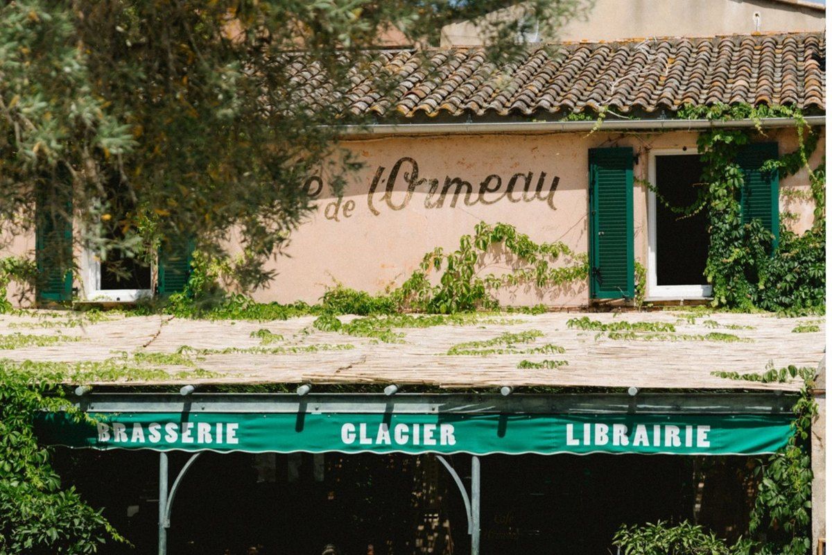 The green awning of the Café de l'Ormeau – brasserie, glacier, librairie – on the village square of Ramatuelle