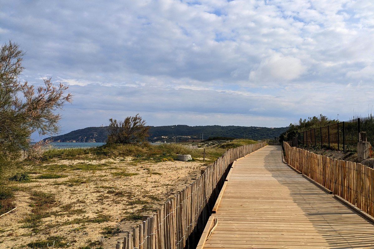 The wooden boardwalk of the greenway through the dunes behind the Plage de Pampelonne