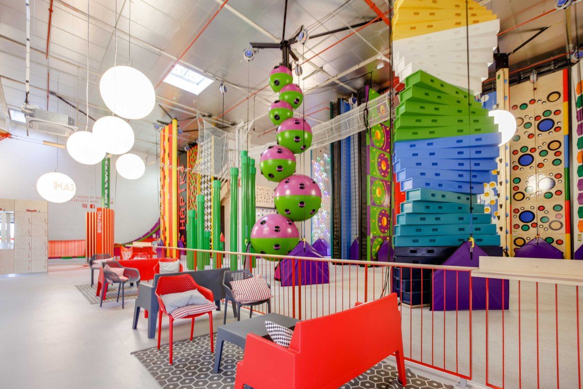 Colourful themed climbing walls and seating inside the Hapik climbing centre at Chambourcy