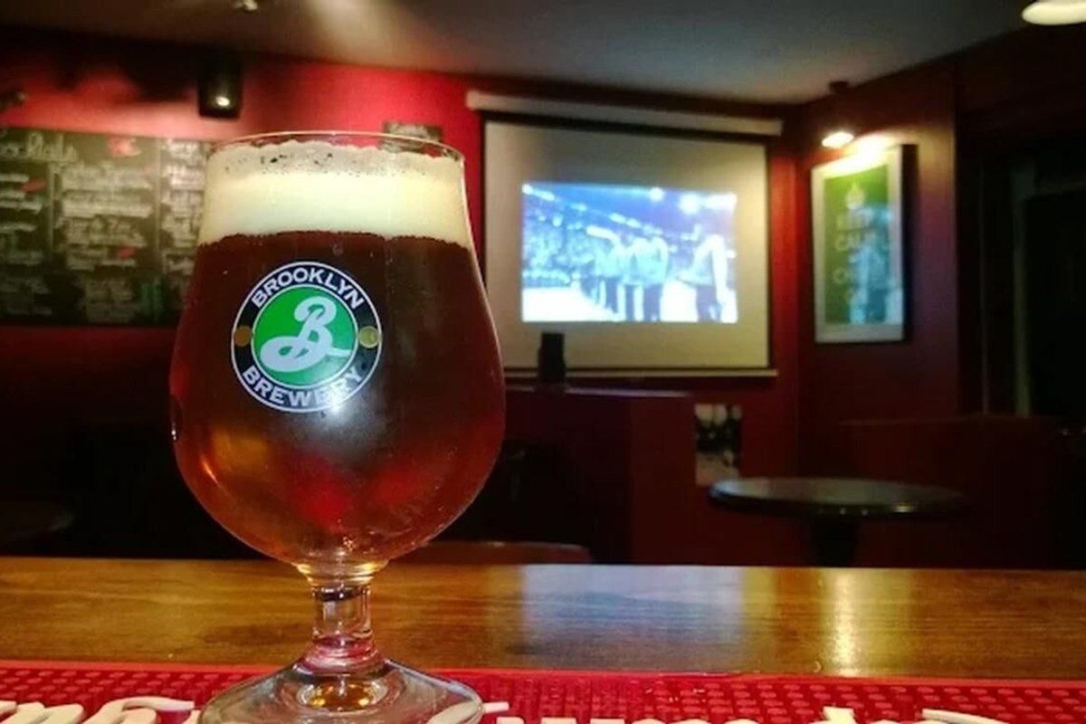 A glass of craft beer on the bar at L'Alchimiste, a cocktail bar in central Saint-Germain-en-Laye