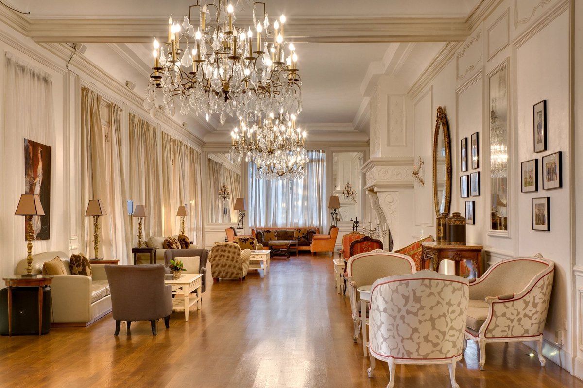 Armchairs under crystal chandeliers in La Galerie, the long lounge of the Pavillon Henri IV in Saint-Germain-en-Laye