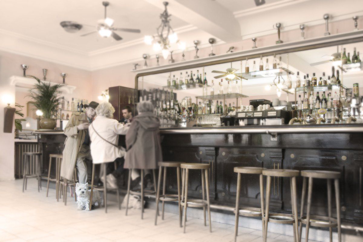 Regulars at the long zinc bar of the Café de la Place in Saint-Paul de Vence