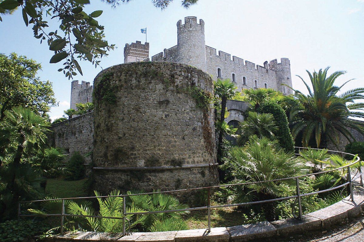 The medieval fortress of Villeneuve-Loubet rising above its gardens