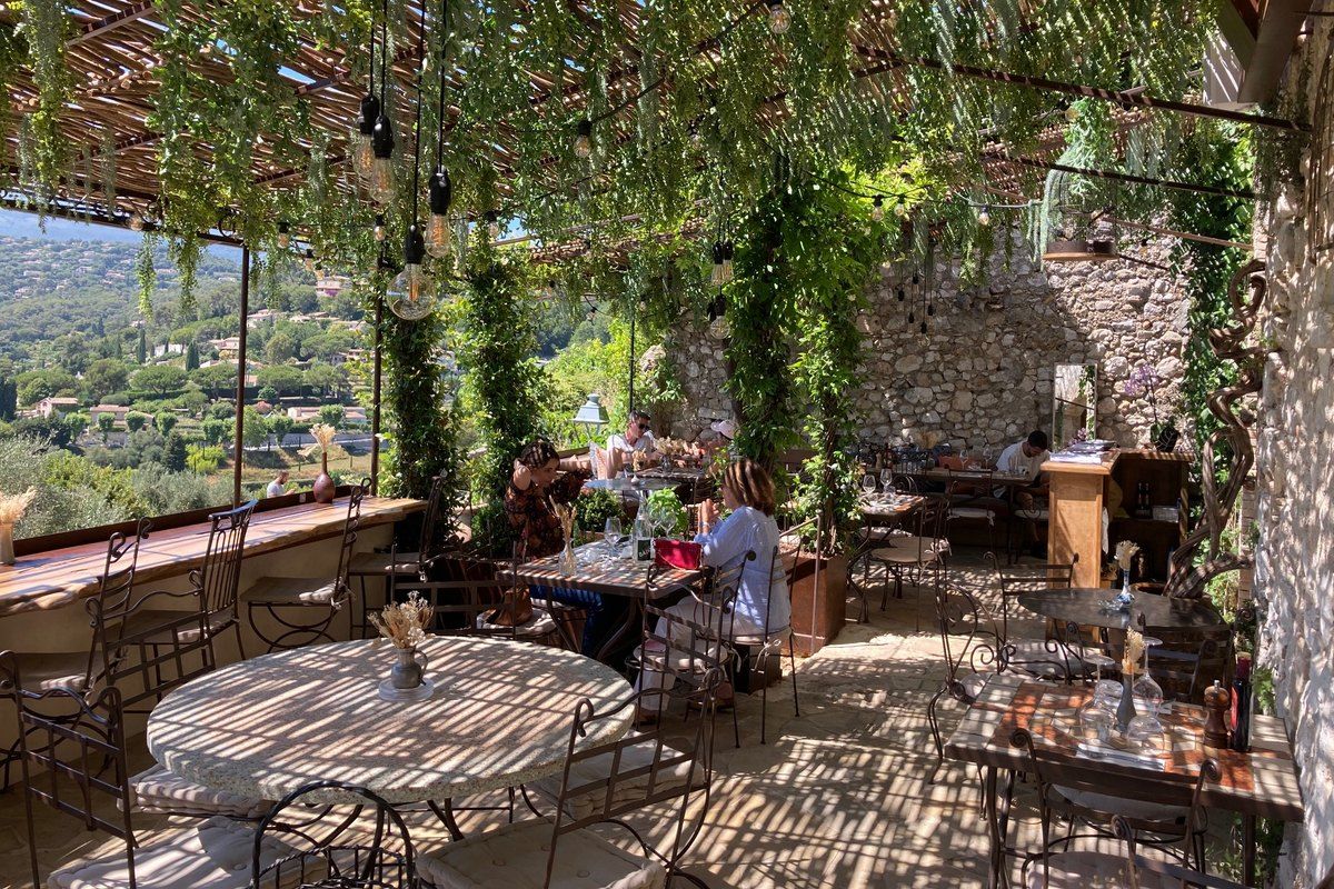 The pergola terrace of Les Remparts on the village walls, looking out over the hills
