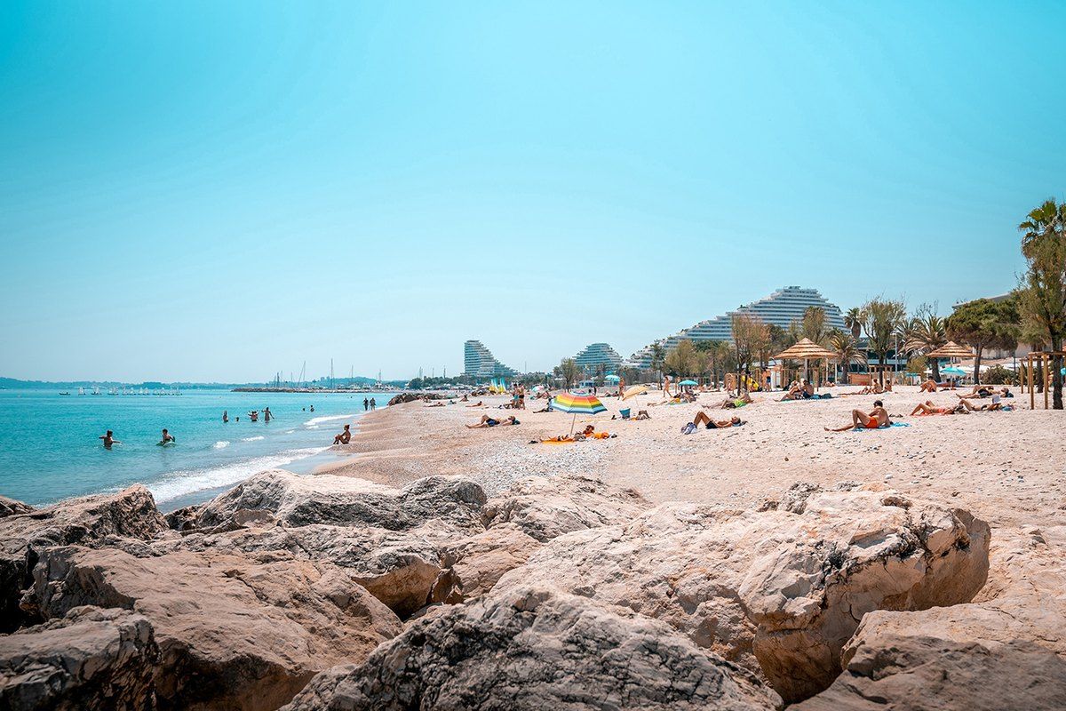 Pebble beach and clear water at Plage du Loup in Villeneuve-Loubet, with the coast stretching away