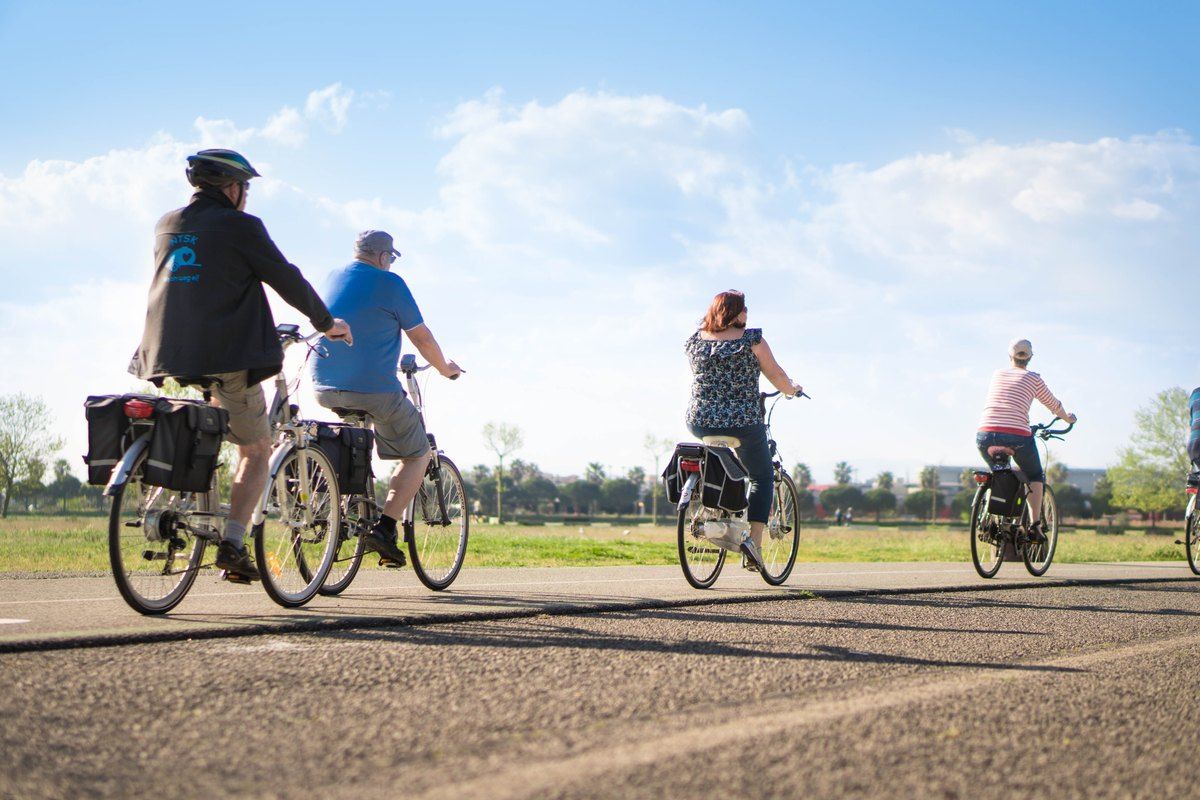 Cyclists on the wide flat paths of the Base Nature François Léotard park in Fréjus