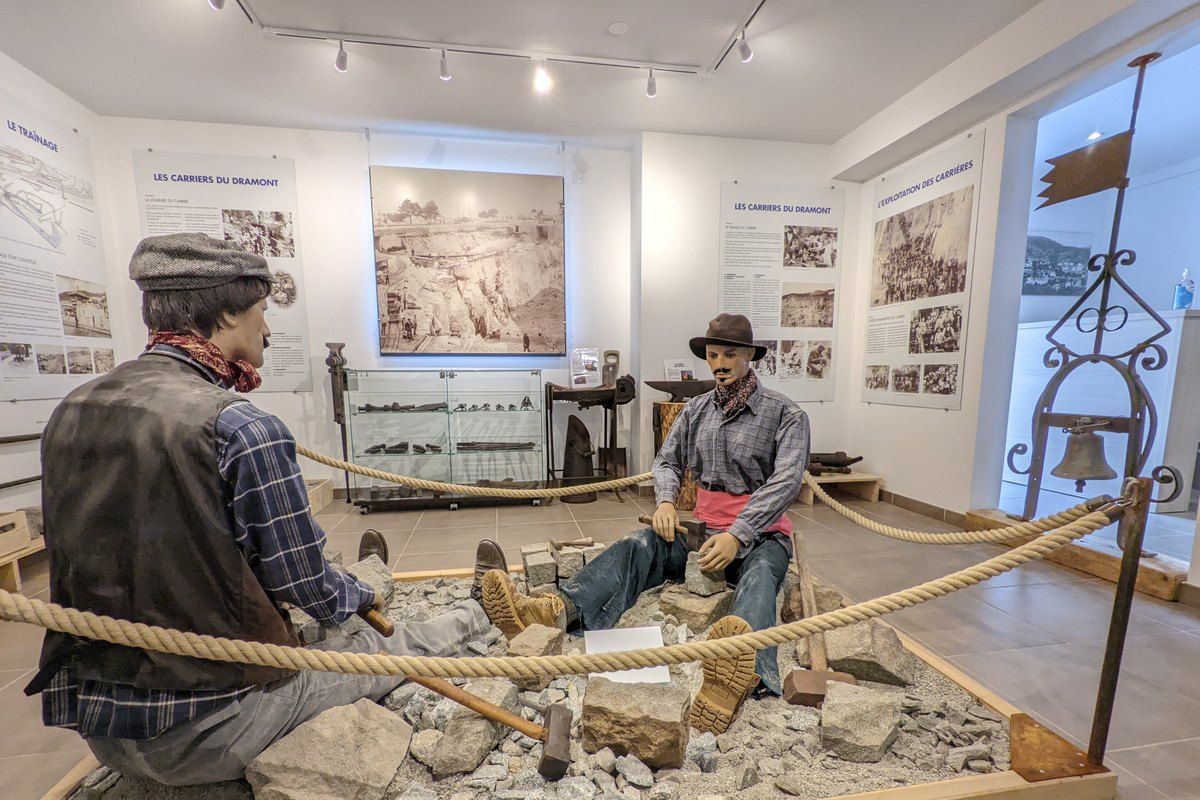 A reconstructed quarry scene with figures of stone workers inside the Maison des Carriers at Le Dramont