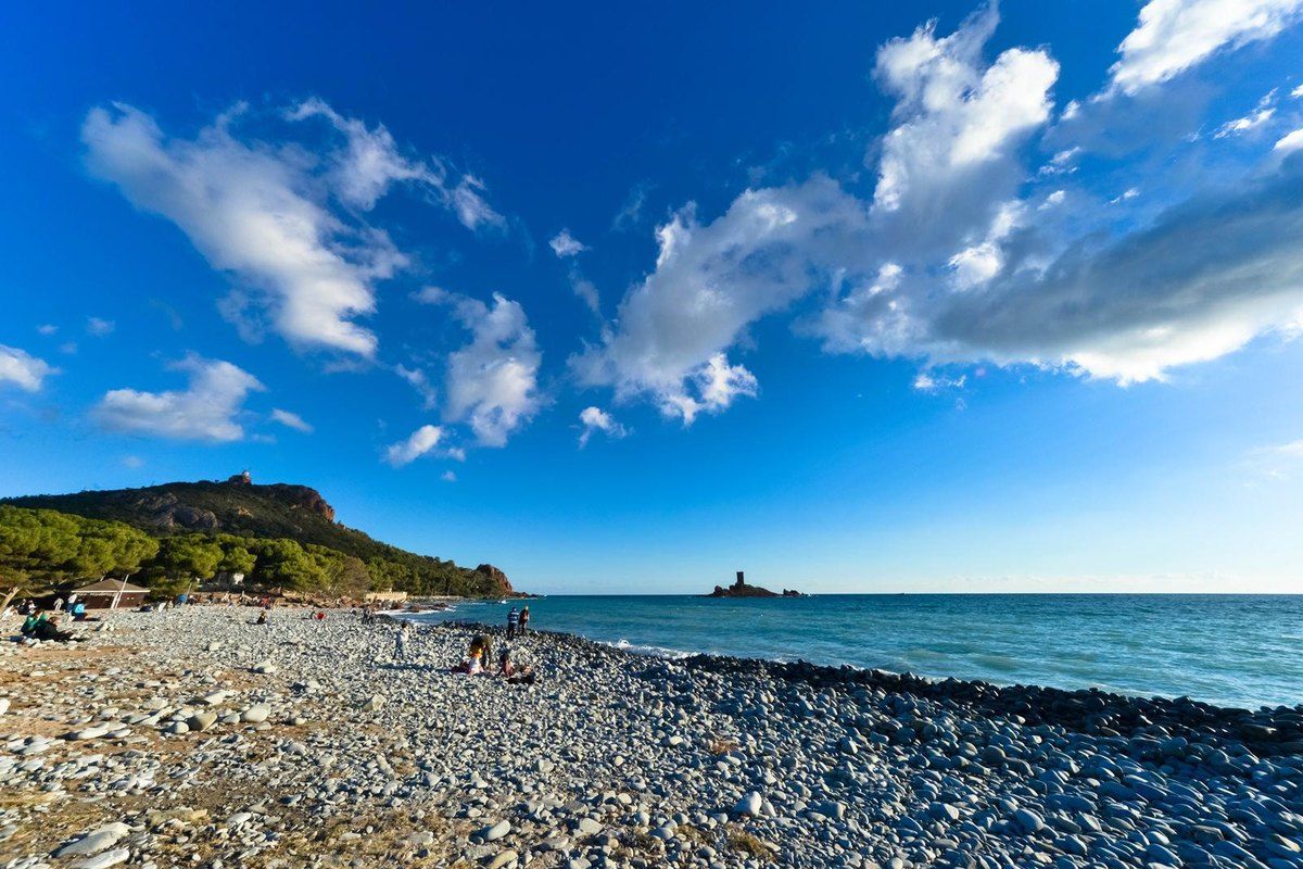 Plage du Débarquement at Le Dramont, a pebble beach looking out to the Île d'Or and its tower