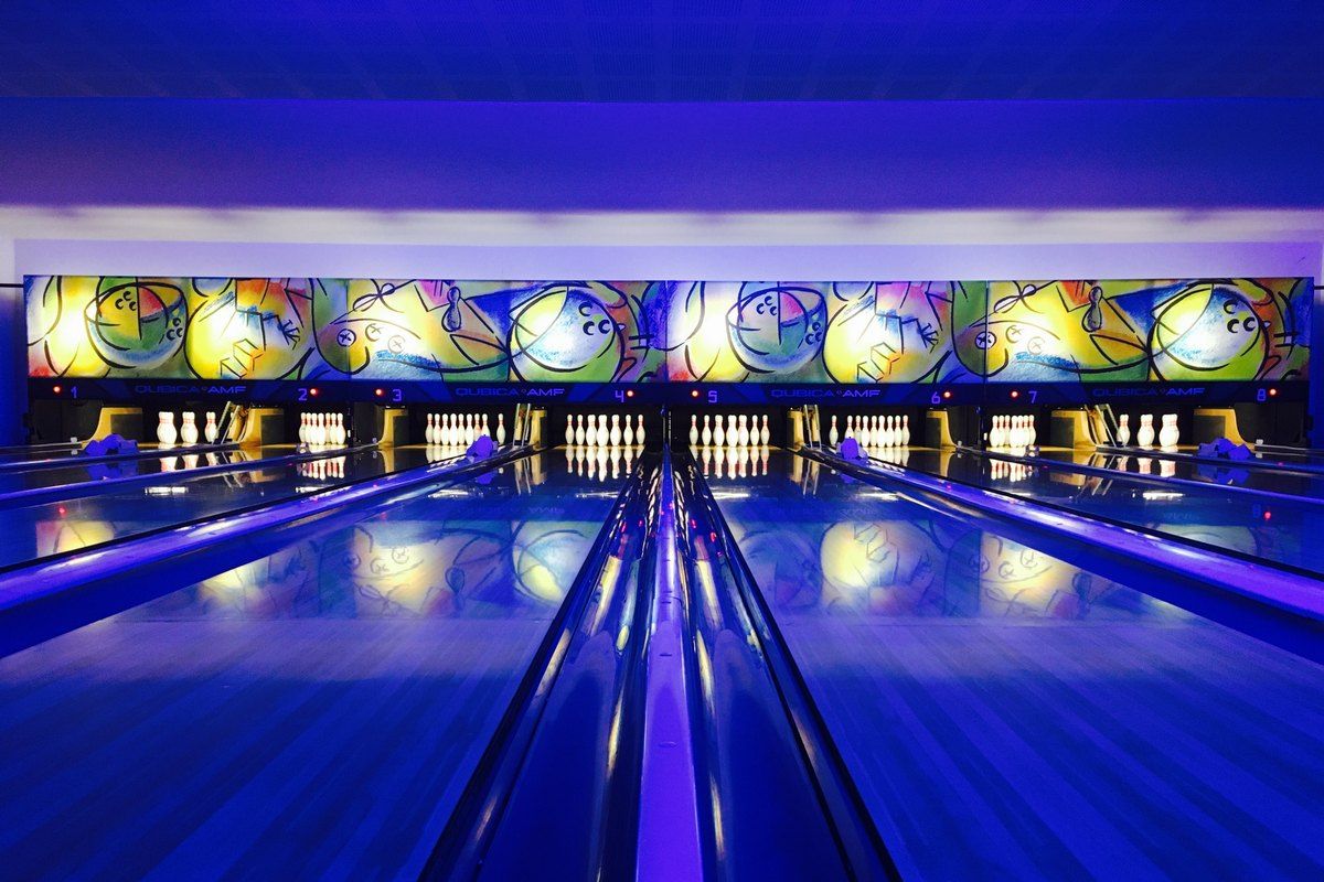 Blue-lit lanes and pin decks at the Bowling du Golfe in Grimaud