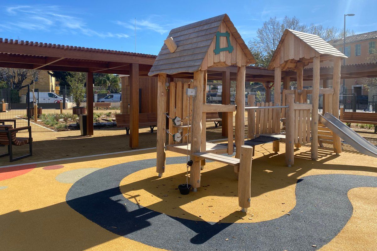 Wooden play huts and a slide in the new Jardin du Couvent public garden, Saint-Tropez