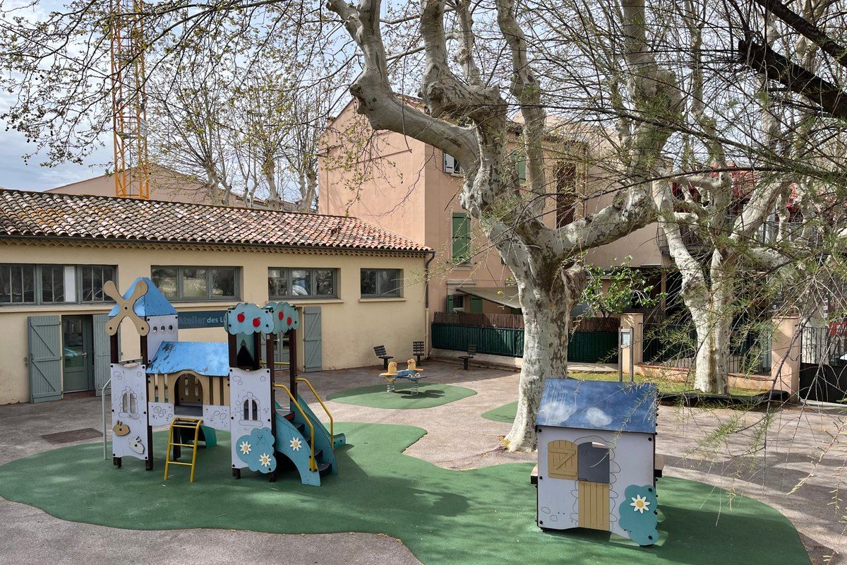 Play equipment under the plane trees of the children's garden on place du XVe Corps, by the Place des Lices