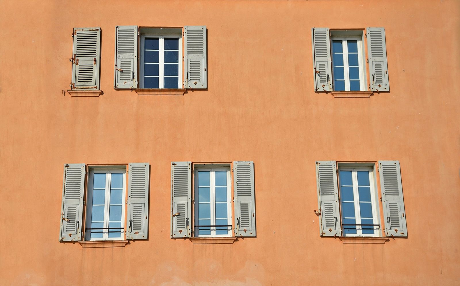 A Provençal house front with grey wooden shutters in Saint-Tropez