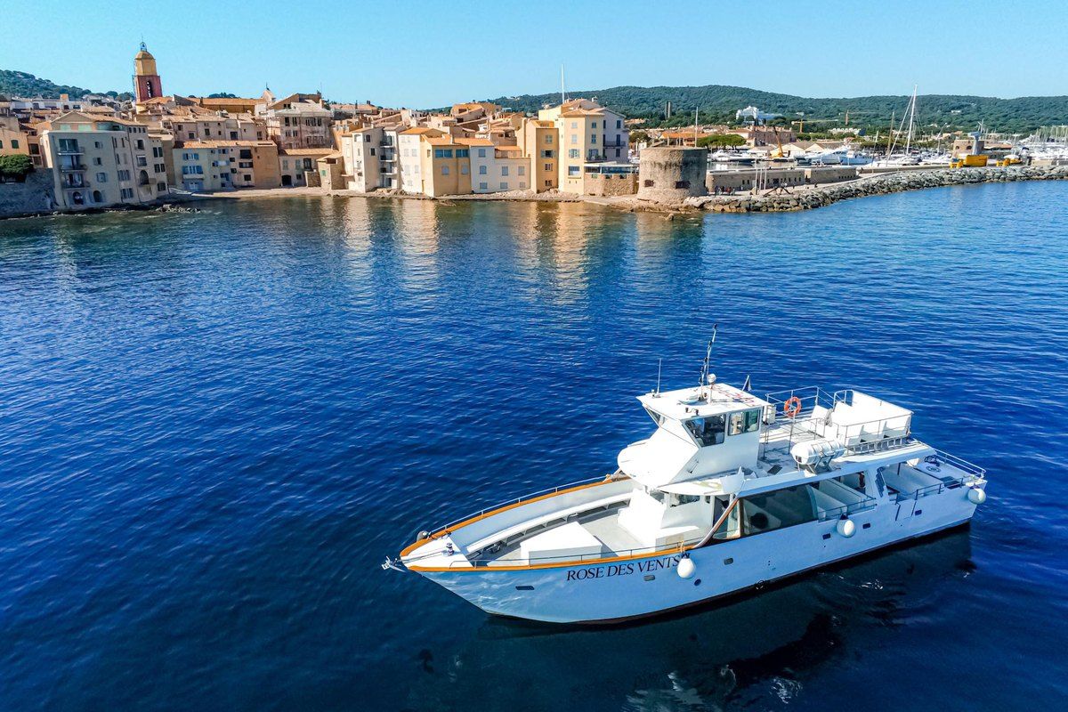 The excursion boat Rose des Vents II on blue water off the old town of Saint-Tropez