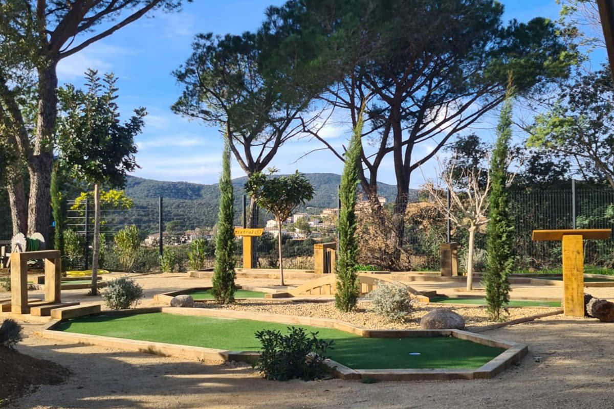 Mini-golf holes among cypresses and pines at Mini-Golf Aventure Famille, Sainte-Maxime