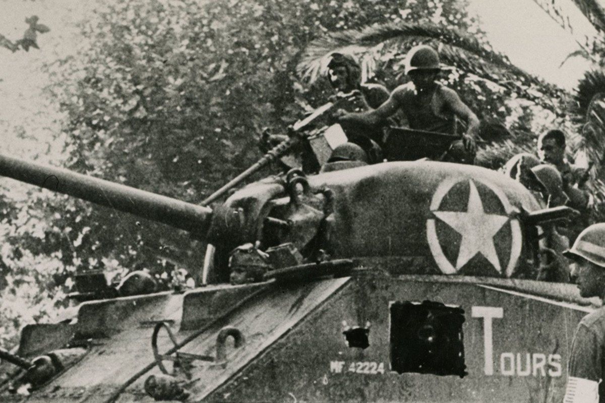 Archive photograph of a US Sherman tank named Tours carrying soldiers during the Liberation of Provence in August 1944