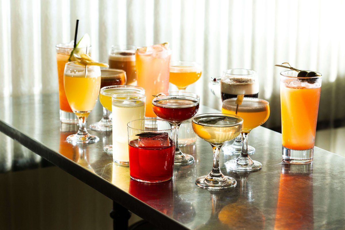 A row of brightly coloured cocktails lined up on the steel bar counter at Tjoget in Hornstull
