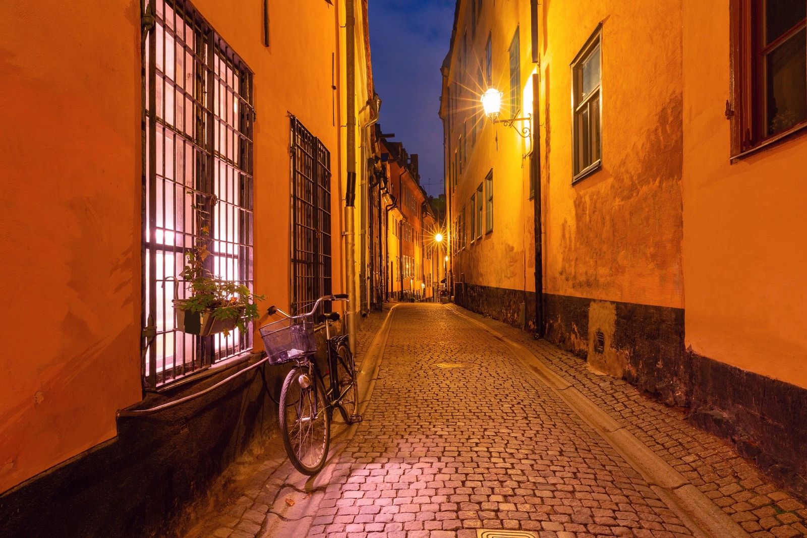 A quiet, narrow cobbled street in Gamla Stan at dusk