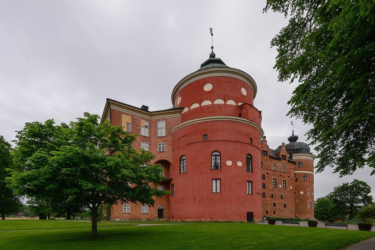 The great round red-brick tower of Gripsholm Castle in Mariefred, seen across the lawn