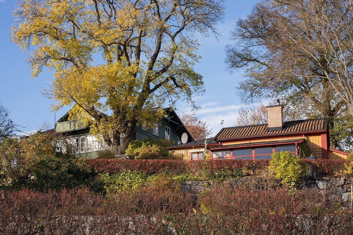 Golden October trees and old wooden houses at Blockhusudden on the eastern tip of Djurgården