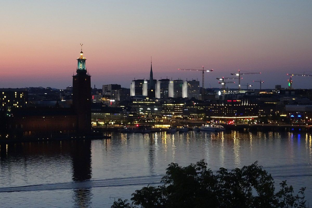 Dusk over Riddarfjärden from Skinnarviksberget, with the City Hall tower and Kungsholmen's lights mirrored in the water