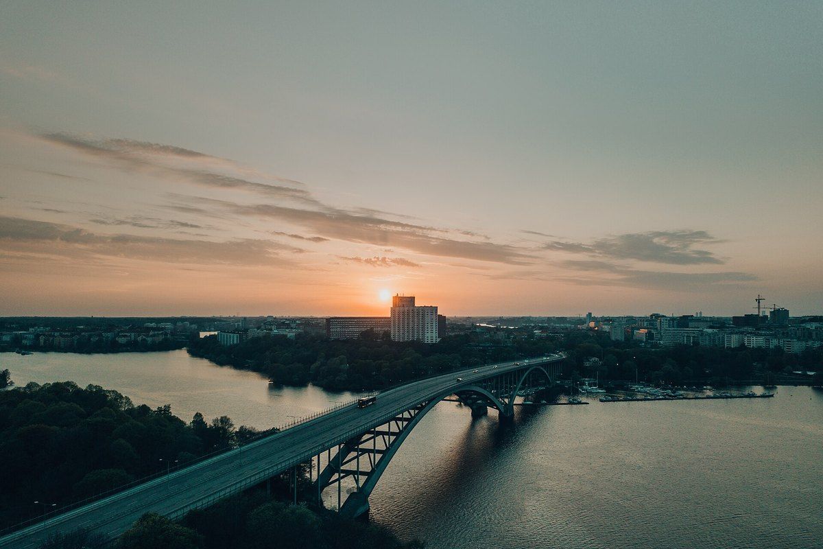 The arches of Västerbron spanning Riddarfjärden at sunset, seen from the air