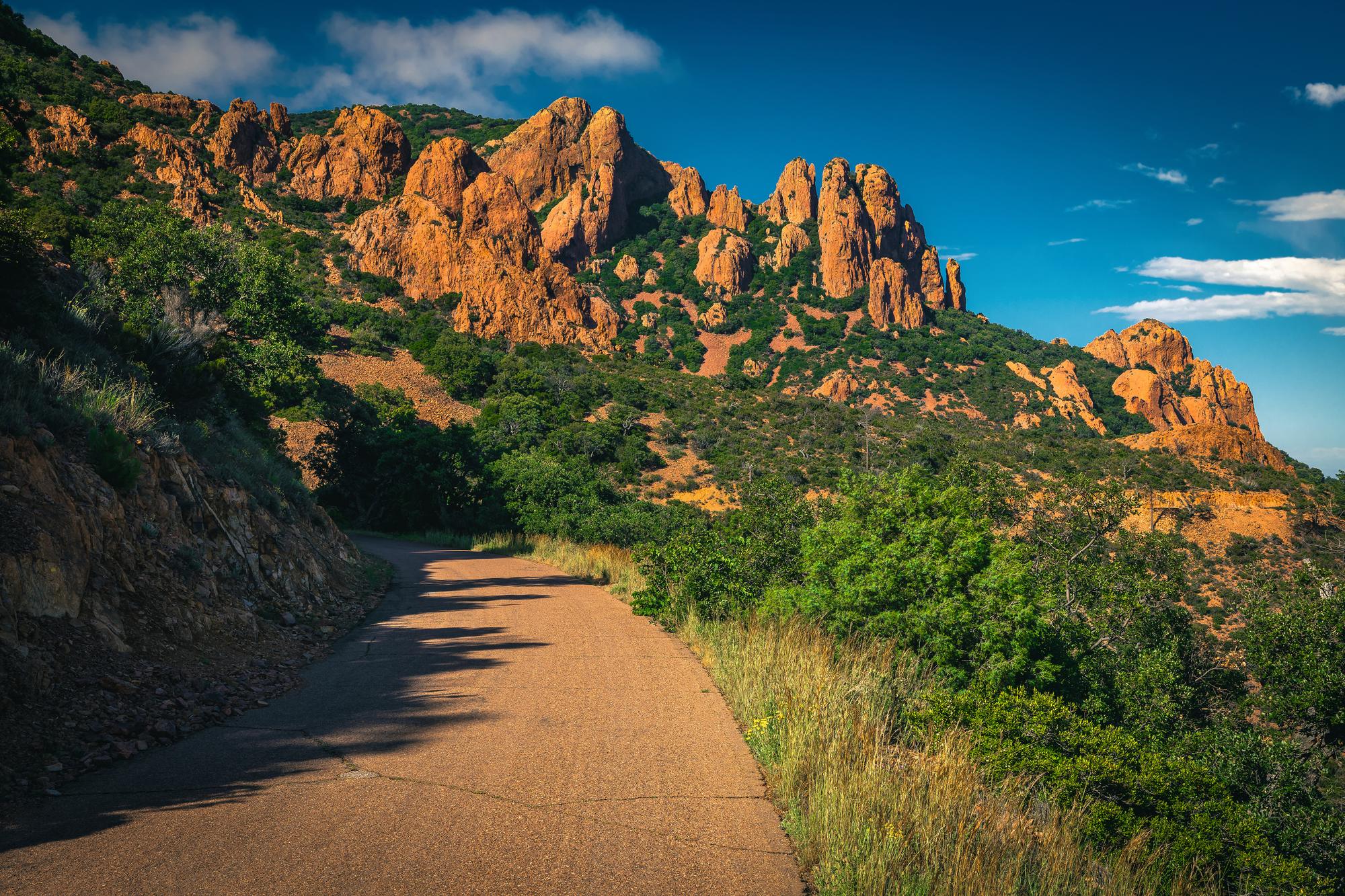 A winding road through the red rocks of the Esterel