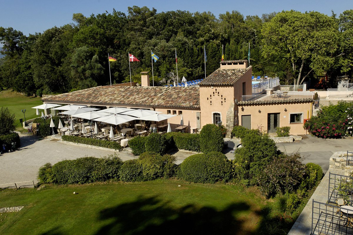 The Château de la Bégude and its parasol-shaded terrace above the golf course at Opio