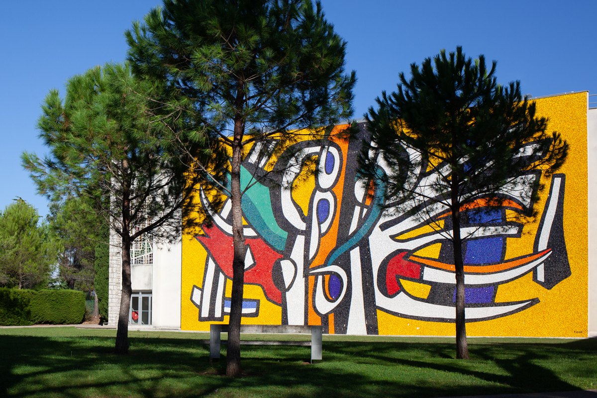 The giant coloured mosaic on the façade of the Musée national Fernand Léger seen across its park in Biot