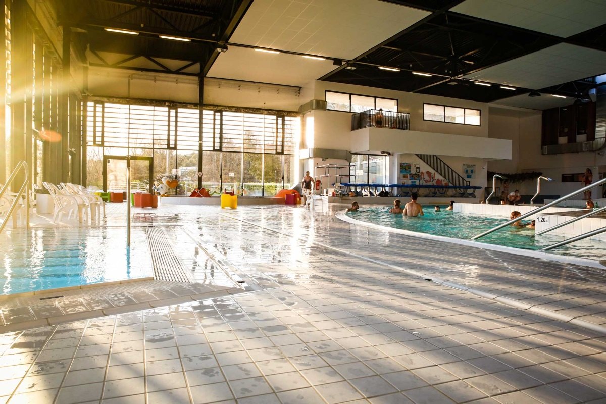 The sunlit indoor leisure pool hall at the Nautipolis aquatic centre in Sophia Antipolis