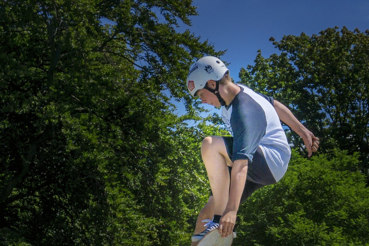 A skateboarder mid-trick at the Vignasse skate park in Valbonne village