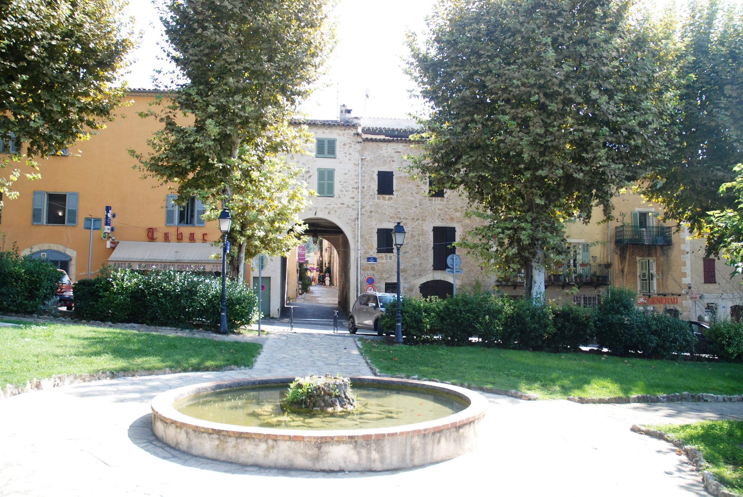 A fountain and lawns on a square in Valbonne village