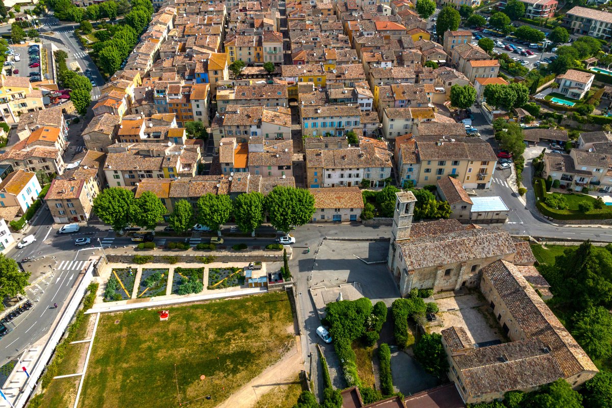 Aerial view of Valbonne village and its grid of streets beside the abbey church and its gardens