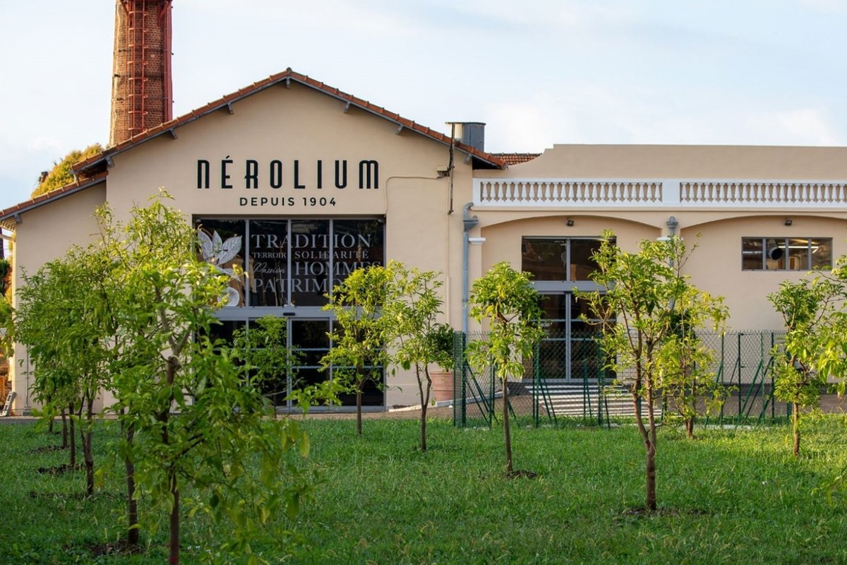 The 1904 Nérolium distillery building in Golfe-Juan, with its brick chimney and young bitter-orange trees on the lawn